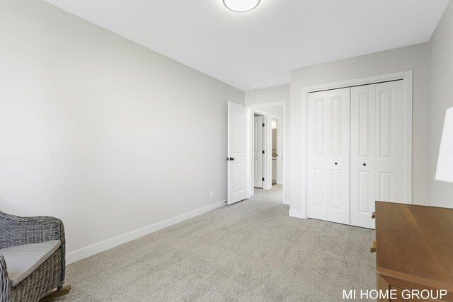 unfurnished bedroom with a closet and light colored carpet