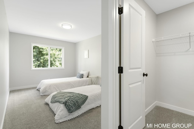 bedroom featuring baseboards and carpet