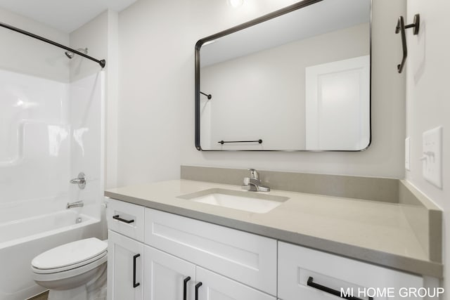 bathroom featuring vanity, toilet, and washtub / shower combination