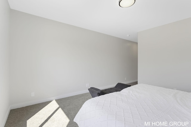 carpeted bedroom with baseboards