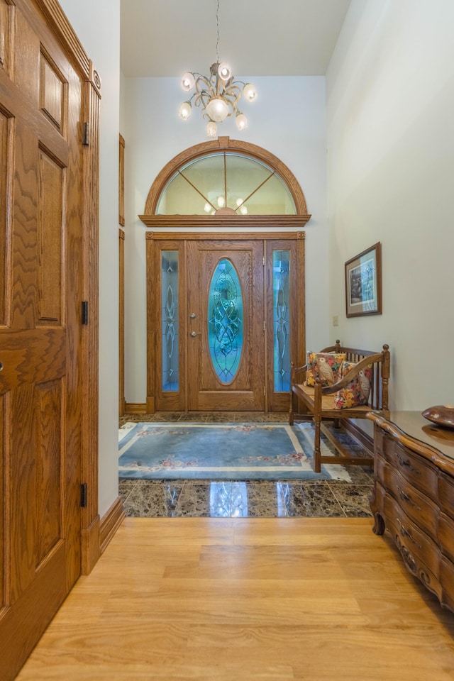 foyer entrance featuring an inviting chandelier and wood-type flooring