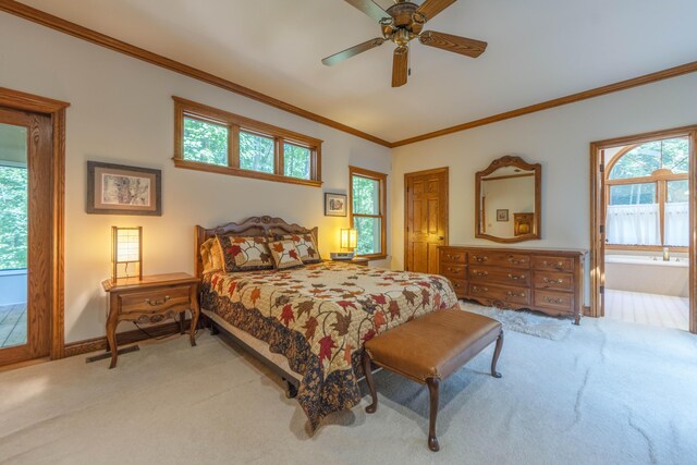 bedroom with carpet flooring, ceiling fan, crown molding, and ensuite bath