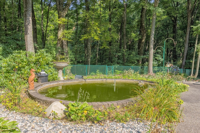 surrounding community featuring a garden pond