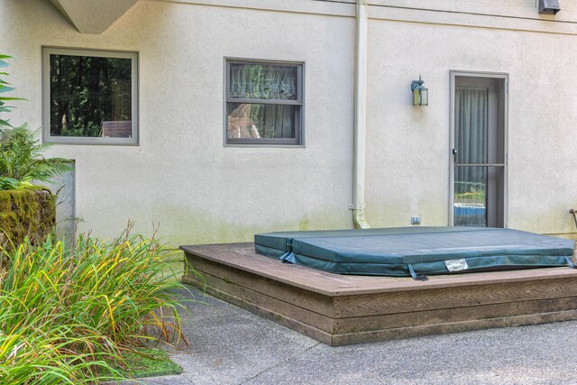 exterior space with a covered hot tub