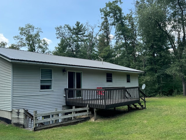 back of house with a yard and a deck