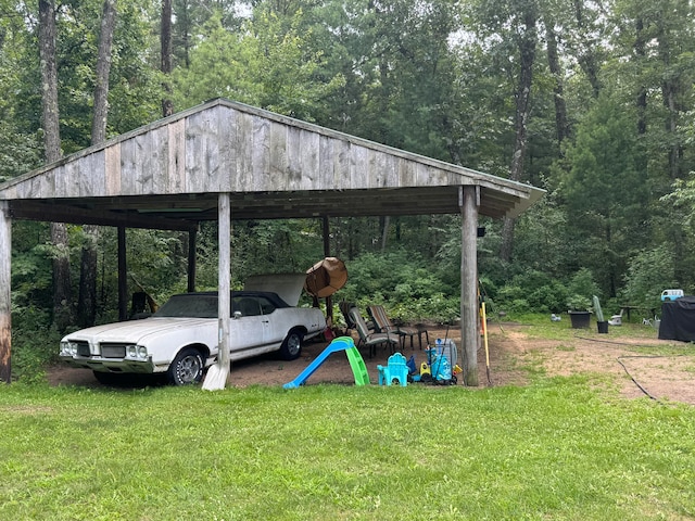 view of car parking with a yard and a carport