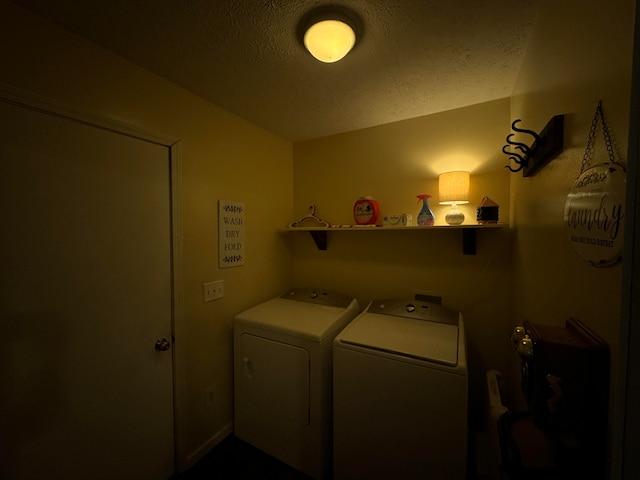 laundry area with a textured ceiling and washer and clothes dryer