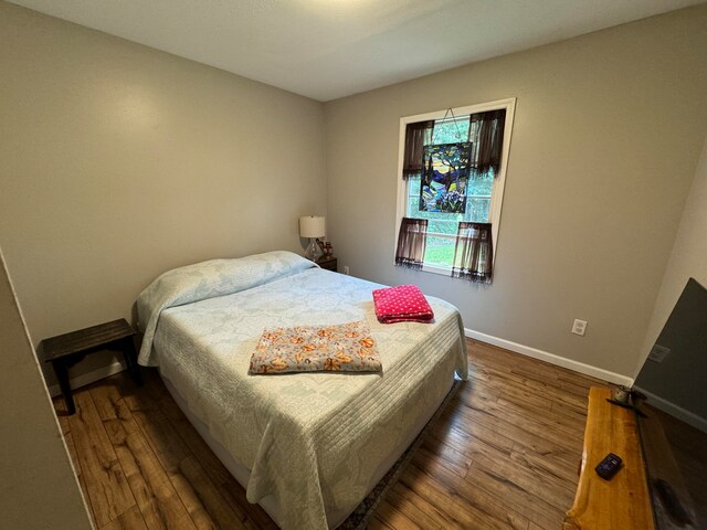 bedroom featuring dark hardwood / wood-style flooring