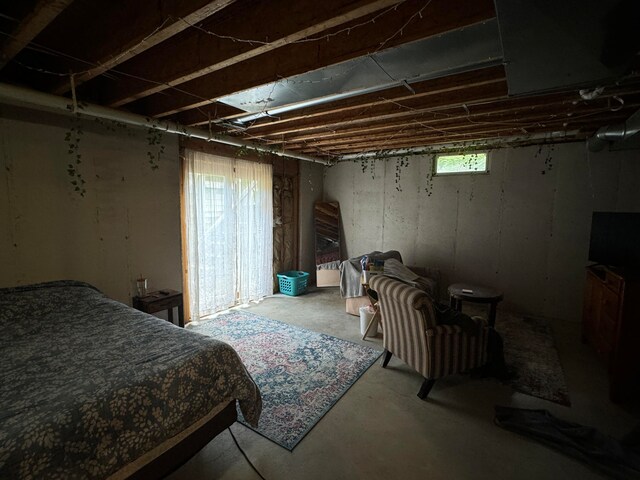 bedroom featuring concrete floors