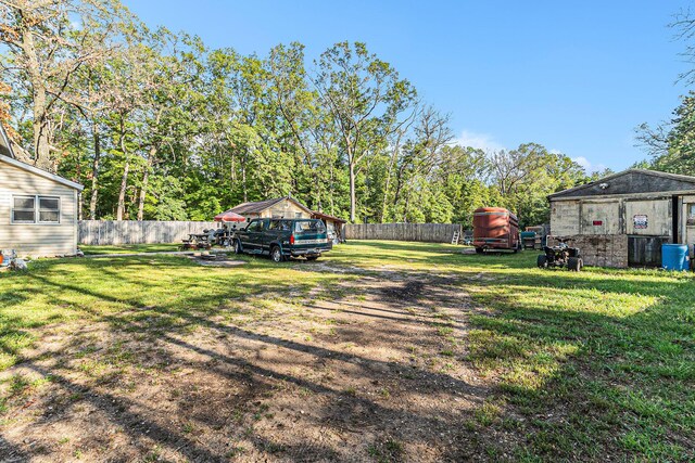 6991 E Apple Ave, Muskegon, MI 49442 - view of yard featuring a fenced backyard and an outdoor structure