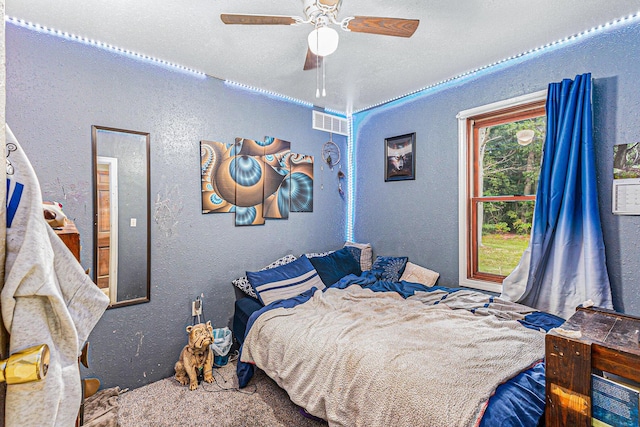 6991 E Apple Ave, Muskegon, MI 49442 - bedroom with visible vents, a ceiling fan, and a textured wall