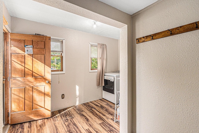 6991 E Apple Ave, Muskegon, MI 49442 - laundry room featuring laundry area, wood finished floors, a textured wall, and washer / dryer