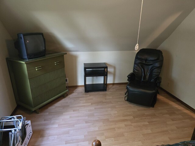 sitting room featuring vaulted ceiling and light hardwood / wood-style floors