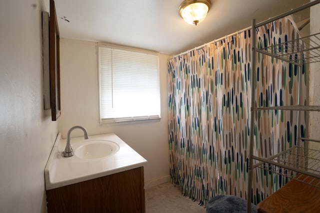 bathroom featuring curtained shower and vanity