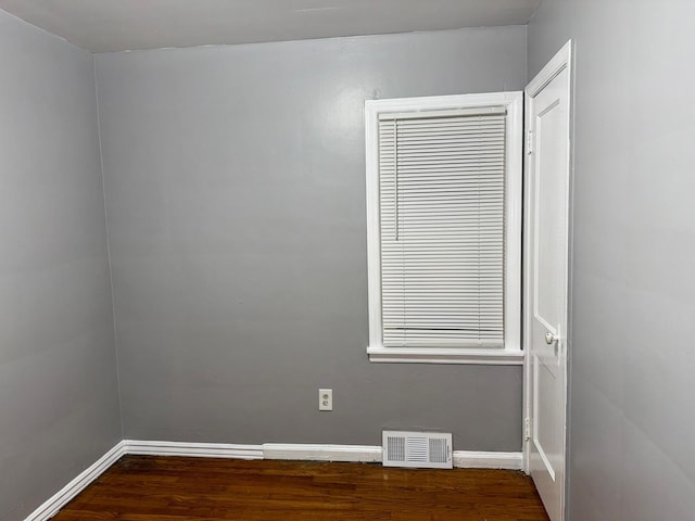 spare room featuring dark hardwood / wood-style floors