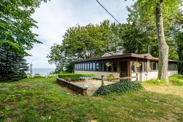 rear view of house featuring a patio area and a yard