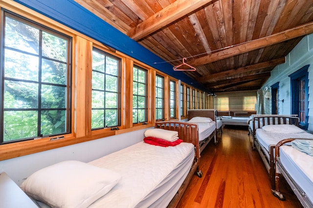 bedroom featuring wooden ceiling, lofted ceiling with beams, and wood finished floors