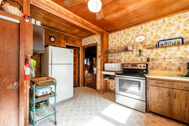 kitchen featuring white appliances, light floors, wallpapered walls, light countertops, and wood ceiling