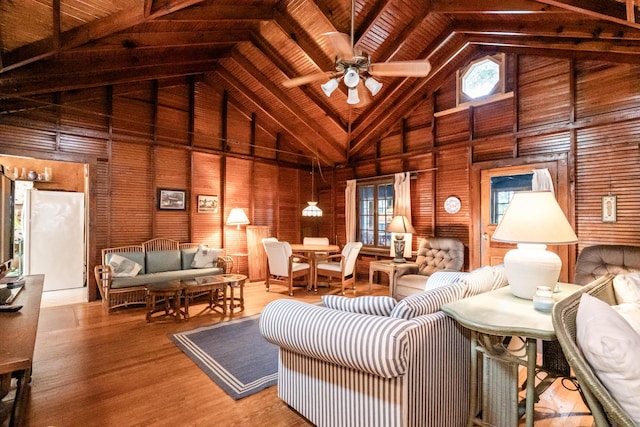 living room with high vaulted ceiling, a ceiling fan, and wood finished floors