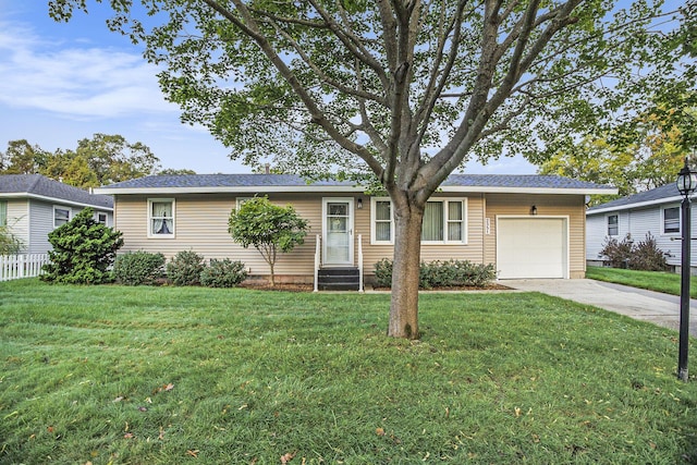 ranch-style house featuring a garage and a front yard