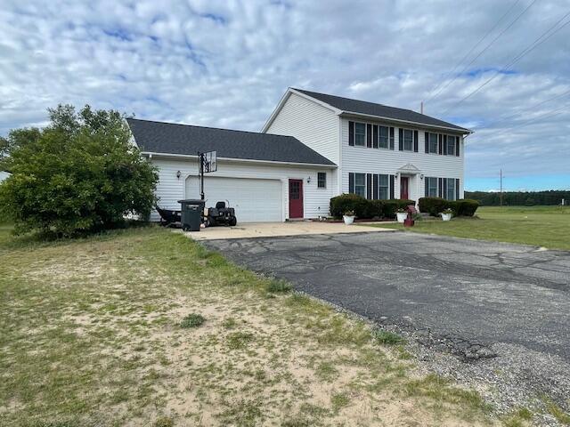 view of front of house with a garage and a front yard