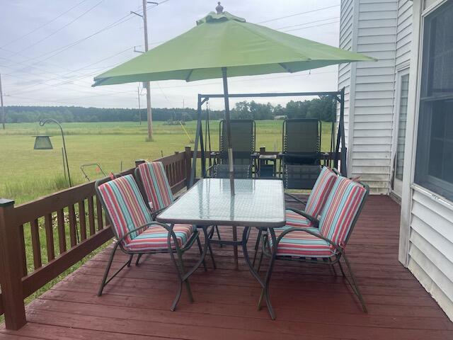 wooden terrace featuring a yard