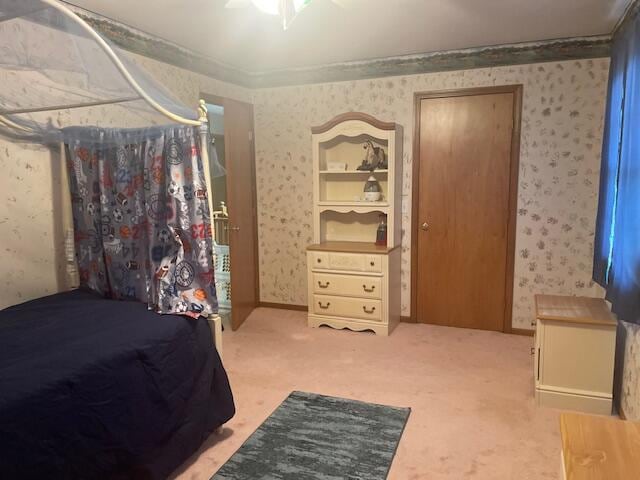 bedroom with ornamental molding and carpet