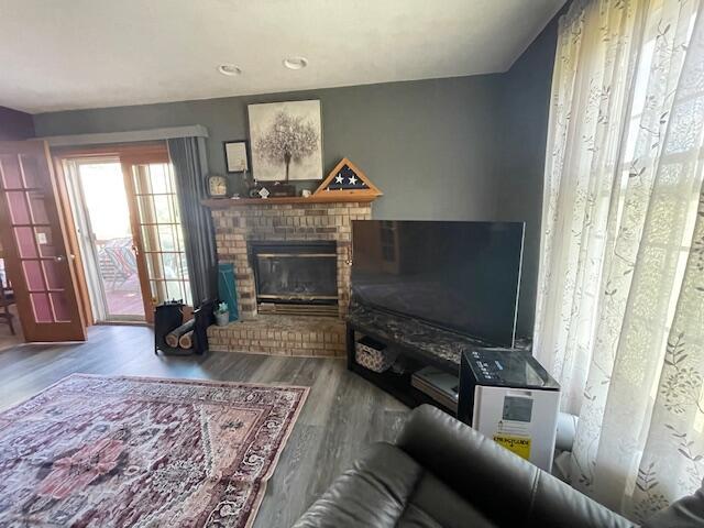 living room with wood-type flooring and a fireplace