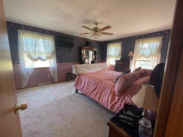 bedroom with ceiling fan and carpet flooring