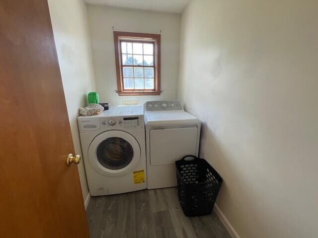 laundry area featuring hardwood / wood-style floors and washing machine and clothes dryer