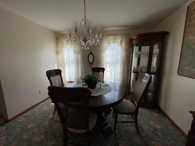 dining area with an inviting chandelier