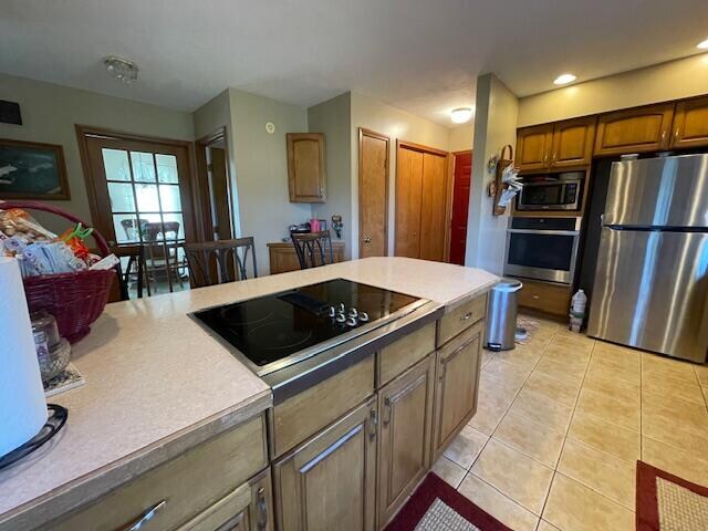 kitchen featuring light tile patterned floors and appliances with stainless steel finishes