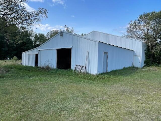 view of outbuilding featuring a yard