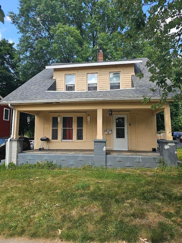 view of front of home featuring a porch and a front lawn