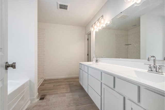 bathroom with vanity, hardwood / wood-style floors, and independent shower and bath