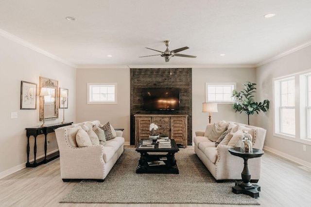 living room with ornamental molding, ceiling fan, and light hardwood / wood-style floors