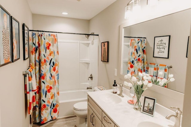 full bathroom with toilet, shower / bath combo with shower curtain, wood-type flooring, and vanity