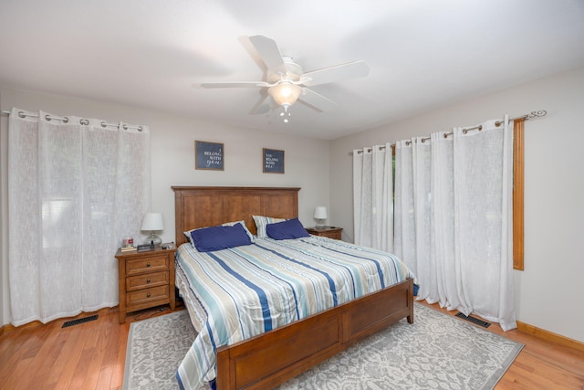 bedroom with ceiling fan and light hardwood / wood-style floors