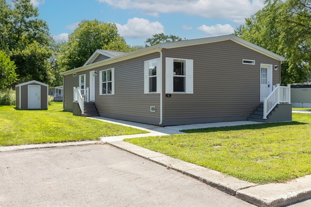 view of front of property featuring a storage shed and a front lawn