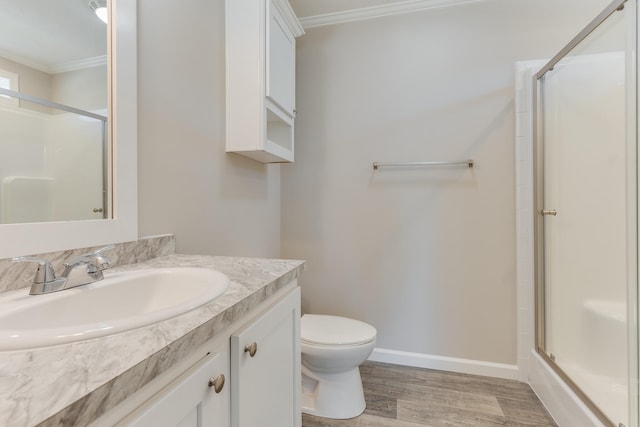 bathroom featuring vanity, an enclosed shower, toilet, ornamental molding, and hardwood / wood-style flooring