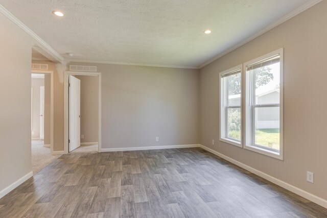 unfurnished room with crown molding, a textured ceiling, and hardwood / wood-style floors