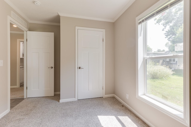 unfurnished bedroom featuring light carpet and ornamental molding