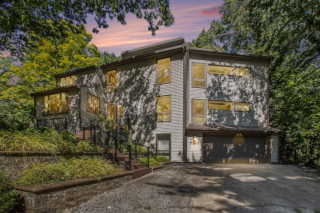 property exterior at dusk featuring a garage