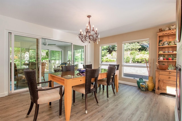 dining space with light wood-type flooring and a chandelier