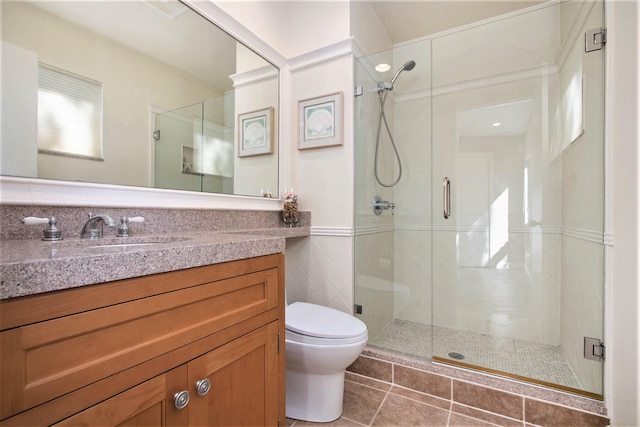 bathroom with tile patterned flooring, walk in shower, toilet, and vanity