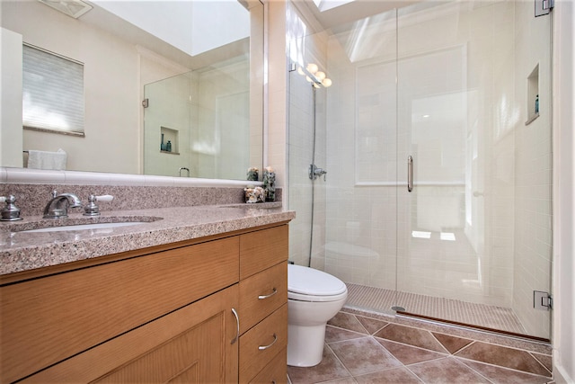 bathroom featuring vanity, toilet, an enclosed shower, and tile patterned floors