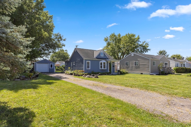 view of front of property with an outbuilding, a garage, and a front yard