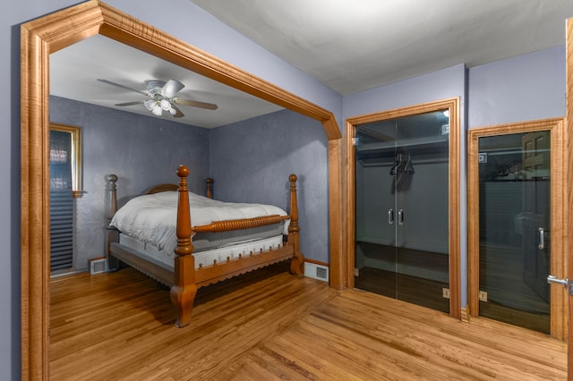 bedroom with a closet, ceiling fan, and light hardwood / wood-style floors