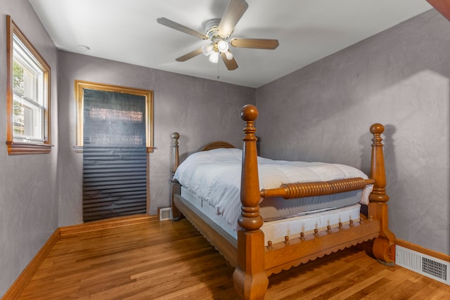 bedroom with wood-type flooring and ceiling fan