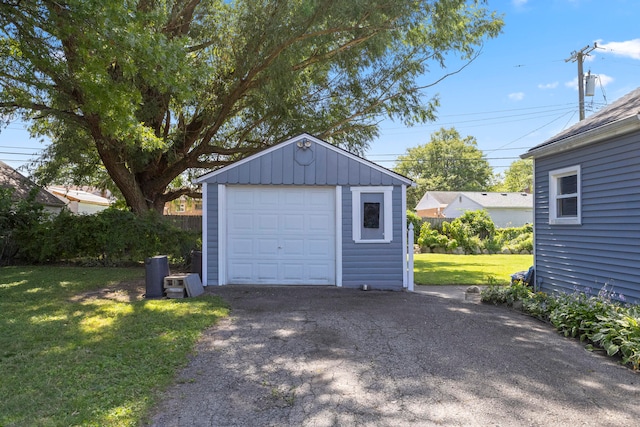 garage featuring a lawn